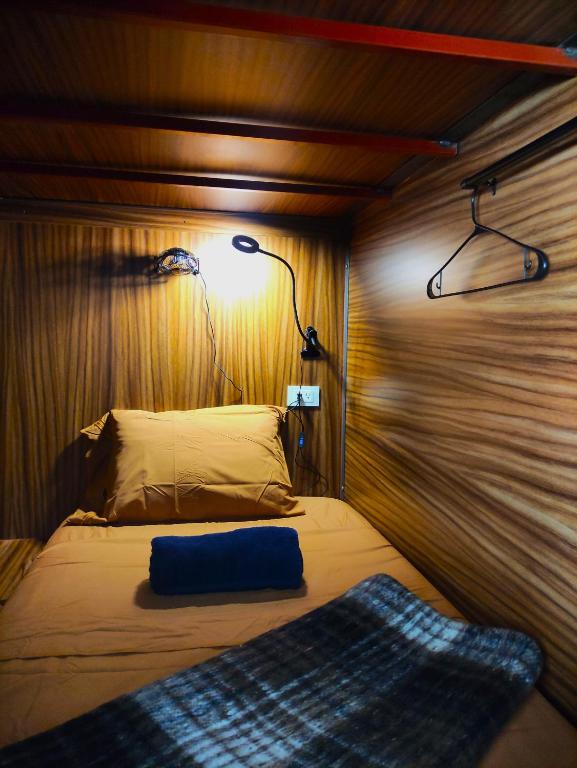 Cama individual en cabina privada con luz.
